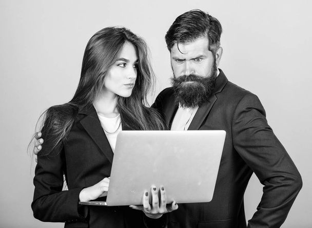 Discussing progress. Woman and guy colleague working together. Business plan. Business lady and director or boss surfing internet. Business meeting. Man bearded manager show financial report laptop - 写真・画像