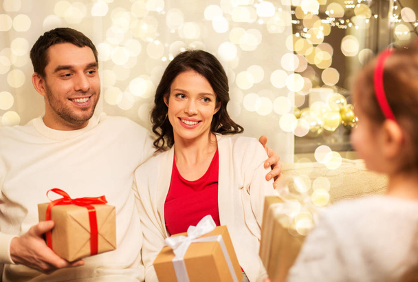 happy family giving christmas presents at home - Foto, imagen