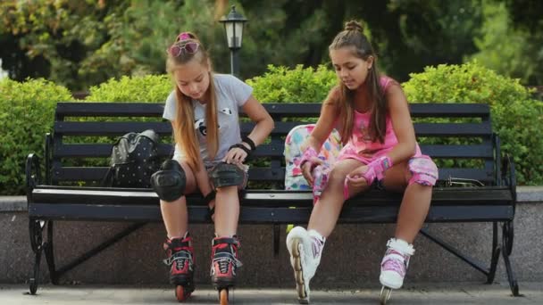 Young teen girls preparing for roller-skating - Footage, Video
