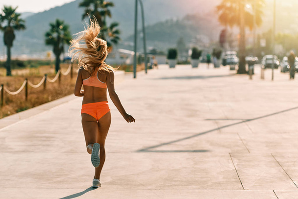healthy lifestyle young woman runner running on the street. - Foto, imagen