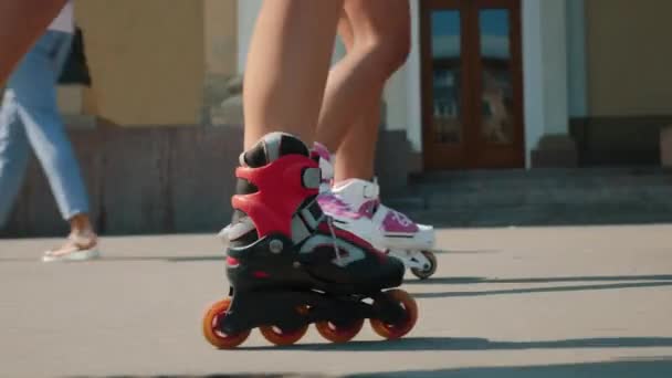 Two girls rollerblading in the town square - Footage, Video