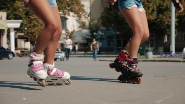 Two young girls rollerblading on the square in the city - Footage, Video