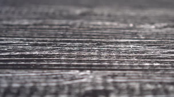 A small handful of flax seeds falls on a black wooden surface. Slow motion, diet food concept - Filmagem, Vídeo