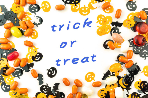 Halloween dekoráció Trick vagy Treat szöveg és Jellybean cukorka elszigetelt - Fotó, kép