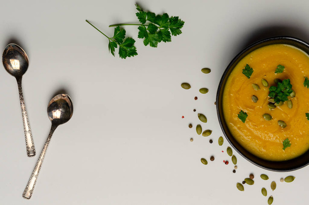 Pumpkin soup with pumpkin seeds on white background. top view - Photo, Image