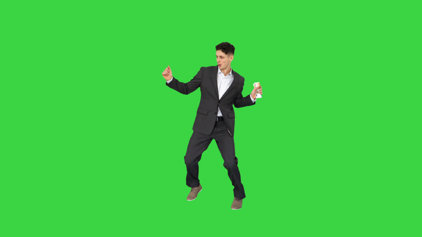 Young happy businessman dancing after counting salary Win dance on a Green Screen, Chroma Key. - Footage, Video