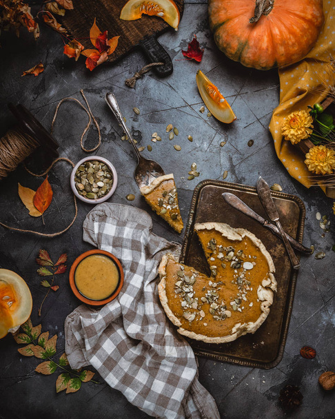 pumpkin pie decorated with pumpkin seeds on metal tray with textile  - Fotoğraf, Görsel
