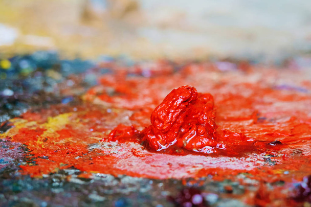 Red oil paint on the palette - Photo, Image