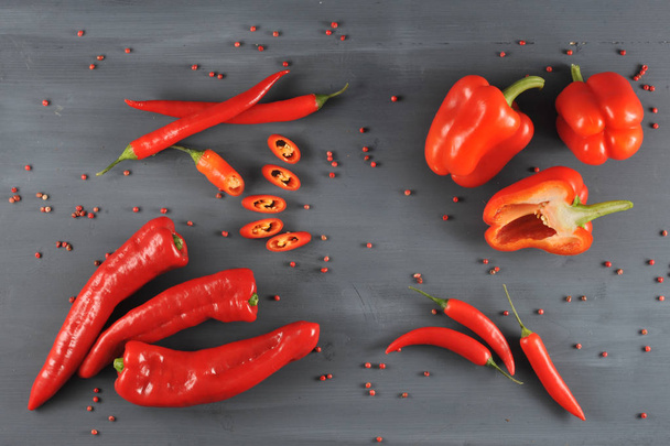 A set of a variety of red pepper. In the frame, pepper is cayenne, sweet and Ramiro sort. Dark wooden background. Close-up. View from above. - 写真・画像