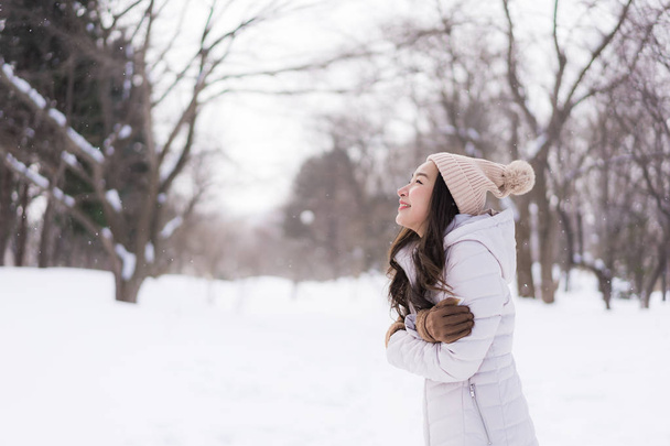 Hermosa joven asiática mujer sonriendo feliz para viajar en la nieve ganar
 - Foto, Imagen