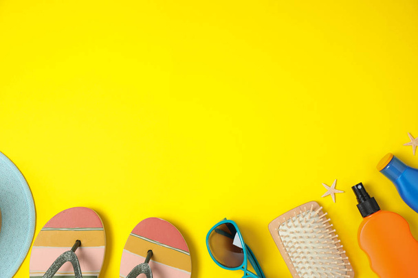 Flat lay composition with beach accessories on yellow background, space for text - Fotoğraf, Görsel