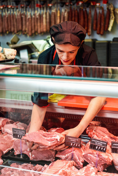 Butchers hands holding meat piece in shop - Photo, Image