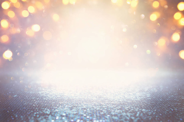 background of abstract glitter lights. silver, light blue and gold. de-focused. - 写真・画像