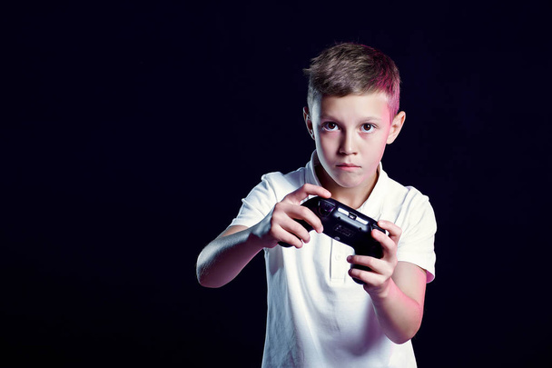 Excited kid playing video game in studio - Foto, Imagen