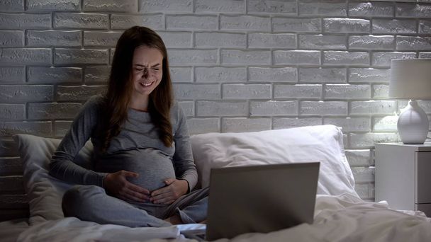 Pregnant woman crying while watching drama, increased emotionality, hormones - Zdjęcie, obraz