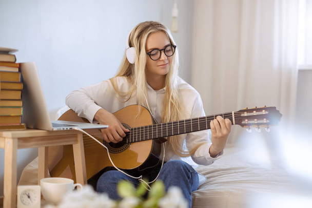 Girl Playing Guitar at Home - 写真・画像