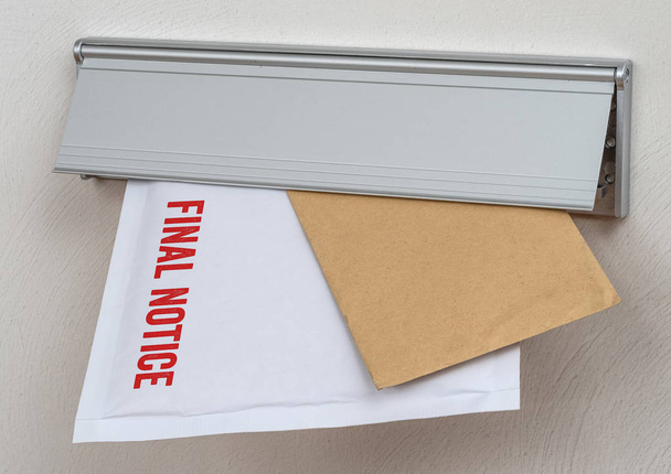 A letter labeled Final notice in a mail slot - Photo, Image