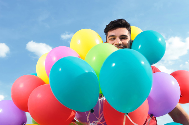 casual man surrounded by baloons - Foto, imagen