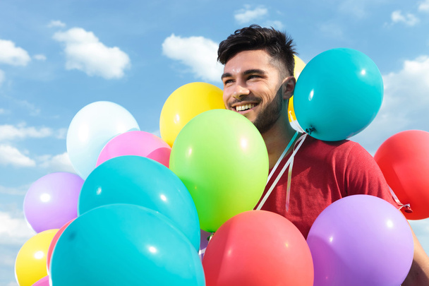 casual man with baloons all over him - Zdjęcie, obraz