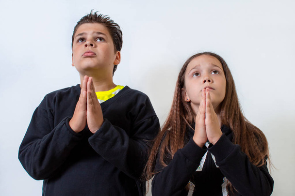 A little girl and a boy pray. Children ask for something - Photo, image