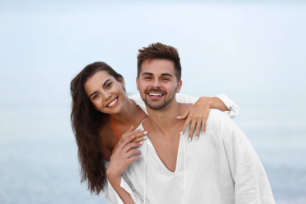 Happy young couple spending time together on beach - Foto, Imagen