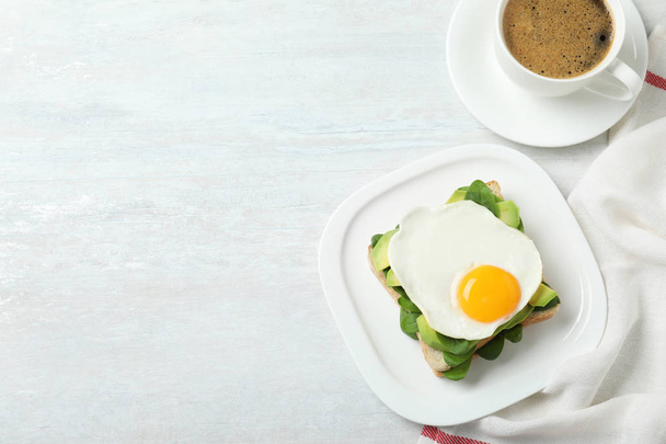 Delicious breakfast with fried egg served on table, flat lay. Space for text - Foto, Bild