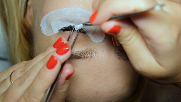 Eyelash Extension Procedure. Woman Eye with Long Eyelashes. Lashes, close up - Foto, imagen