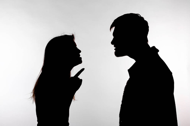 Aggression and abuse concept - man and woman expressing domestic violence in studio silhouette isolated on white background. - Φωτογραφία, εικόνα