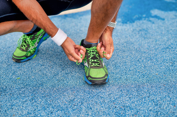 Man adjusting sport shoes laces - Photo, Image