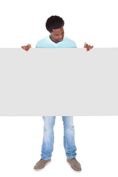 Young Man Standing Behind The Placard - Fotó, kép