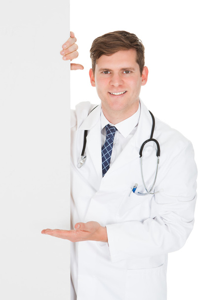 Male Doctor Holding Blank Placard - Фото, изображение