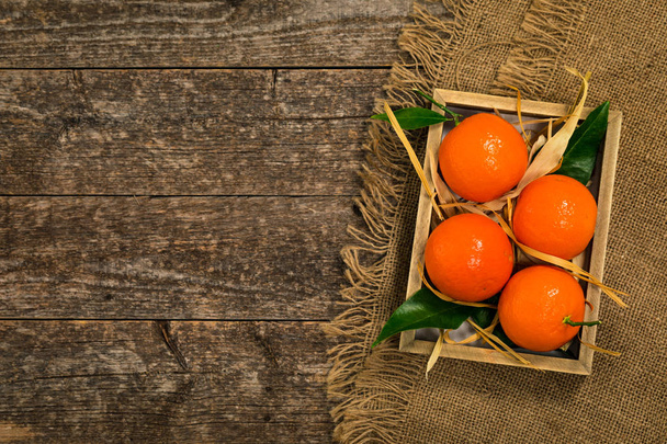 Mandarin Orange or Tangerines on wooden background. Selective focus. - 写真・画像