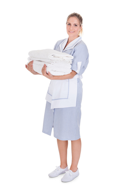 Happy Young Maid Holding Towels - Foto, imagen