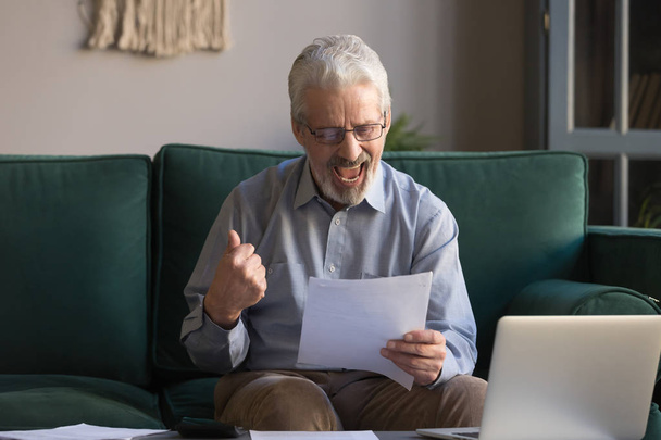 Excited elderly man get good news in paper correspondence - Foto, immagini