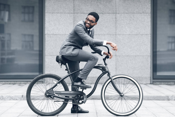 Zachowaj spokój i jeździć. Biznesmen na rowerze przeciwko Buiding biura - Zdjęcie, obraz