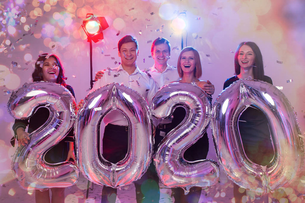 Party, people and new year holidays concept - women and men celebrating new years eve 2020 - Foto, Bild