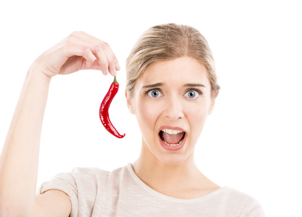 Woman with a silly face holding a red chilli pepper - Foto, Imagem