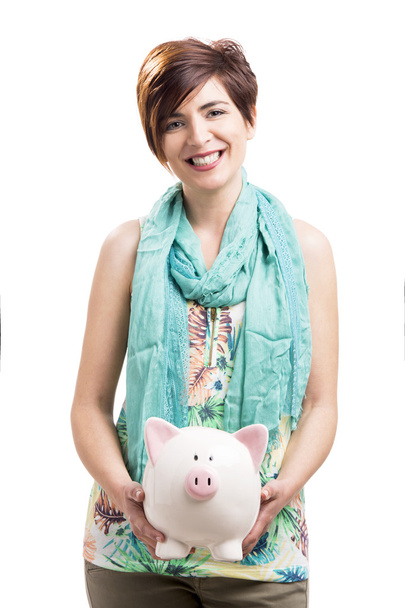 Happy woman with a piggy bank - Fotoğraf, Görsel