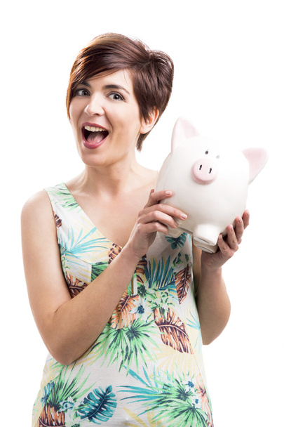 Admired woman with a piggy bank - Fotoğraf, Görsel