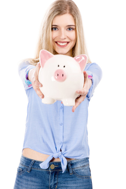 Beautiful woman holding a piggy bank - Фото, зображення