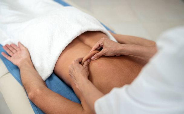 Female doctor doing lumbar massage in hospital - Φωτογραφία, εικόνα