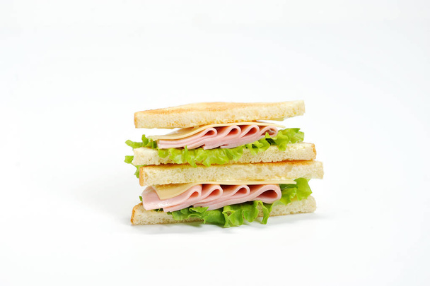 Sandwich with ham and cheese from white bread. The sandwich occupies the space of the frame. Close-up. Macro photography. - Photo, image