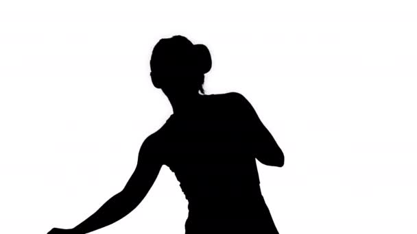 Silhouette Happy smiling young girl using VR headset glasses playing dancing game. First time. - Záběry, video