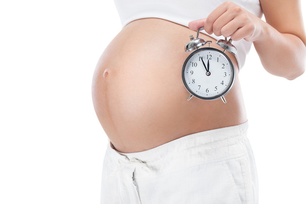 Pregnant woman with clock - Фото, зображення