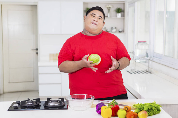 Overweight man kicking soft drink and fast food - Valokuva, kuva
