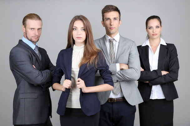 Business team standing in row on grey background - Фото, изображение