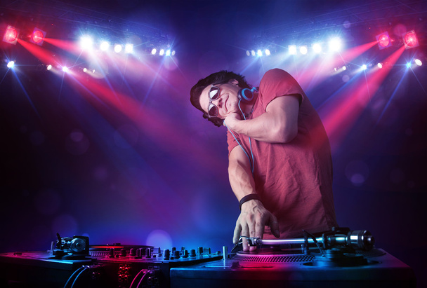 Teenager dj mixing records in front of a crowd on stage - Foto, Imagem
