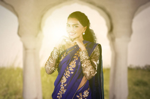 Shy woman wearing a blue saree clothes - Fotoğraf, Görsel