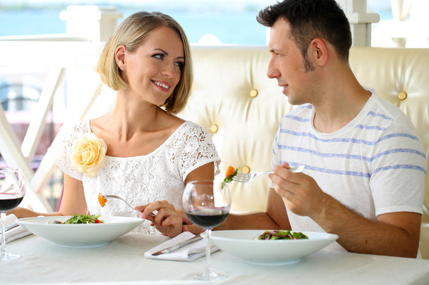 Beautiful couple having romantic dinner at restaurant - Фото, изображение
