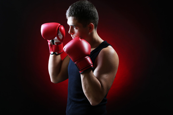 Handsome young muscular boxer on dark background - Фото, зображення